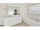 Main bathroom with a double vanity and a jetted tub at 3013 Camille Ln, Mcdonough, GA 30253