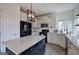 Bright kitchen has a center island, stainless appliances, white cabinets and subway tiles at 233 Yorkshire Ln, Villa Rica, GA 30180