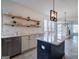 Bright kitchen features a center island, stainless dishwasher and wooden open shelves at 233 Yorkshire Ln, Villa Rica, GA 30180