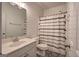 Bright bathroom with decorative tile flooring, a tub/shower with a stylish curtain, and neutral accents at 233 Yorkshire Ln, Villa Rica, GA 30180