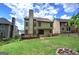 Spacious backyard with a wooden deck, well-maintained lawn, and privacy fencing at 233 Yorkshire Ln, Villa Rica, GA 30180