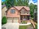 Beautiful two-story brick home featuring a covered front porch and a two-car garage at 233 Yorkshire Ln, Villa Rica, GA 30180