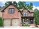 Charming two-story brick home featuring a covered front porch and a two-car garage at 233 Yorkshire Ln, Villa Rica, GA 30180