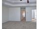 Expansive primary bedroom features soft carpet, tray ceilings, and en-suite bathroom access at 233 Yorkshire Ln, Villa Rica, GA 30180