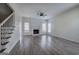Spacious living room with fireplace, hardwood floors, and staircase at 233 Yorkshire Ln, Villa Rica, GA 30180