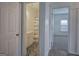 Hallway view of a charming bathroom with decorative tile flooring and a shower/tub combo at 233 Yorkshire Ln, Villa Rica, GA 30180