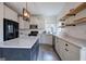 Bright kitchen has wooden floating shelves, white subway tiles, stainless appliances and a center island at 233 Yorkshire Ln, Villa Rica, GA 30180