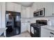 Bright kitchen features white cabinets, stainless appliances and subway tiles at 233 Yorkshire Ln, Villa Rica, GA 30180