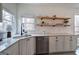 Bright kitchen features open wooden shelving, white cabinets, stainless appliances, and subway tiles at 233 Yorkshire Ln, Villa Rica, GA 30180