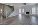 Open-concept living area with fireplace, staircase, and hardwood floors at 233 Yorkshire Ln, Villa Rica, GA 30180