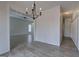 Open-concept dining area with elegant chandelier and wood-look floors flowing into adjacent living space at 233 Yorkshire Ln, Villa Rica, GA 30180