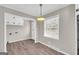 Cozy dining area with wood-look floors and a window at 7125 Flat Rock Se Trl, Covington, GA 30014