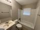 Clean bathroom with a bathtub, sink, and mirror at 1139 Pine Mountain Dr, Forest Park, GA 30297