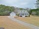 Gray house with a wraparound porch, detached garage, and large yard at 167 Sun Rd, Fayetteville, GA 30214