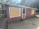 Front view of a red house with boarded windows at 519 Rock Quarry Rd, Austell, GA 30106