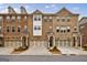 Three-story townhouses with attached garages and attractive landscaping at 4116 Townsend Ln, Dunwoody, GA 30346