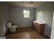 Bathroom with toilet, sink, and a window providing natural light at 4692 College St, Forest Park, GA 30297