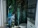 Bathroom with a novelty shower curtain, toilet, and white vanity cabinet and sink at 4692 College St, Forest Park, GA 30297
