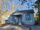 Charming single-story home featuring a covered porch, classic windows, and a compact deck at 4692 College St, Forest Park, GA 30297