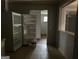 Kitchen with tile flooring, a vintage refrigerator, and a view into another room with a ceiling fan at 4692 College St, Forest Park, GA 30297