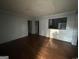 Living room with hardwood flooring, a pass-through to kitchen, and doorways to other rooms at 4692 College St, Forest Park, GA 30297