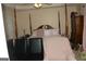 The primary bedroom features a canopy bed, sitting area, and neutral wall color at 3013 Pommel Ct, Conyers, GA 30013