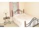Standard bedroom with carpet flooring, window, and a decorative wrought iron bed frame at 3013 Pommel Ct, Conyers, GA 30013