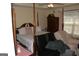 The Primary bedroom features a canopy bed, sitting area, and neutral wall color at 3013 Pommel Ct, Conyers, GA 30013