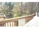 An outside deck with wooden railing overlooking a lush green space at 3013 Pommel Ct, Conyers, GA 30013