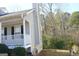 Grey home exterior with white trim, black shutters, chimney, front porch and yard at 3013 Pommel Ct, Conyers, GA 30013