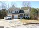 Two-story house with attached garage and covered porch at 3013 Pommel Ct, Conyers, GA 30013