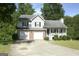 Charming two-story home featuring a two-car garage, brick accents, and a cozy front porch at 3013 Pommel Ct, Conyers, GA 30013