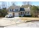 Two-story house with attached garage and covered porch at 3013 Pommel Ct, Conyers, GA 30013