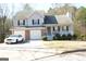 Two-story house with attached garage and covered porch at 3013 Pommel Ct, Conyers, GA 30013