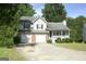 Charming two-story home featuring a two-car garage, brick accents, and a cozy front porch at 3013 Pommel Ct, Conyers, GA 30013