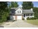 Charming two-story home featuring a two-car garage, brick accents, and a cozy front porch at 3013 Pommel Ct, Conyers, GA 30013
