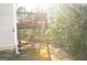 The rear exterior of the home has a raised deck overlooking trees at 3013 Pommel Ct, Conyers, GA 30013