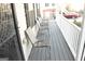 Covered front porch with several metal chairs and freshly painted grey flooring at 3013 Pommel Ct, Conyers, GA 30013