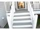 The front porch features newly painted white and gray steps with a painted gray porch at 3013 Pommel Ct, Conyers, GA 30013