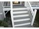 Newly painted white and gray front porch steps with a freshly painted grey porch at 3013 Pommel Ct, Conyers, GA 30013