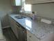 Bright kitchen showcasing a granite countertop, stainless steel sink, and modern faucet at 139 Cecelia Cir, Jonesboro, GA 30236