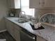 Kitchen boasts granite countertops, stainless steel dishwasher, and ample counter space at 139 Cecelia Cir, Jonesboro, GA 30236