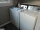 Neat laundry room with white washer and dryer units, maximizing space and efficiency at 139 Cecelia Cir, Jonesboro, GA 30236