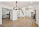Open-concept living room with hardwood floors, modern light fixtures, and stairs to second floor at 3939 Hamilton Mill Rd, Buford, GA 30519
