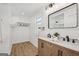Modern bathroom with double sink vanity, black hardware, and an open closet at 3939 Hamilton Mill Rd, Buford, GA 30519