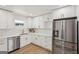 Bright kitchen featuring white cabinets, stainless steel appliances, and modern countertops at 3939 Hamilton Mill Rd, Buford, GA 30519