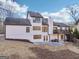 Rear view of the house featuring a patio and deck, set on a spacious lot with mature trees at 3939 Hamilton Mill Rd, Buford, GA 30519