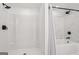 Updated shower tub combination features white tile walls with carrara marble accents at 3939 Hamilton Mill Rd, Buford, GA 30519