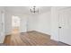 Bright bedroom with hardwood floors, modern light fixture, and a large closet at 3939 Hamilton Mill Rd, Buford, GA 30519