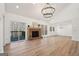 Bright living room with vaulted ceiling, modern light fixtures, fireplace, and sliding glass door to deck at 3939 Hamilton Mill Rd, Buford, GA 30519